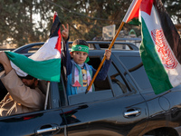 Palestinians in northern Syria commemorate October 7, 2024, by waving Palestinian flags and driving through the streets in their cars. (