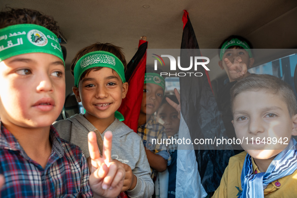 Palestinians in northern Syria commemorate October 7, 2024, by waving Palestinian flags and driving through the streets in their cars. 