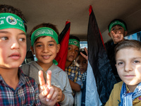 Palestinians in northern Syria commemorate October 7, 2024, by waving Palestinian flags and driving through the streets in their cars. (