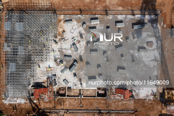 Workers work at the construction site of the second phase of the Foshan -- East and West Guizhou Cooperative Industrial Park in Congjiang Co...