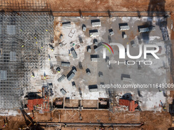 Workers work at the construction site of the second phase of the Foshan -- East and West Guizhou Cooperative Industrial Park in Congjiang Co...