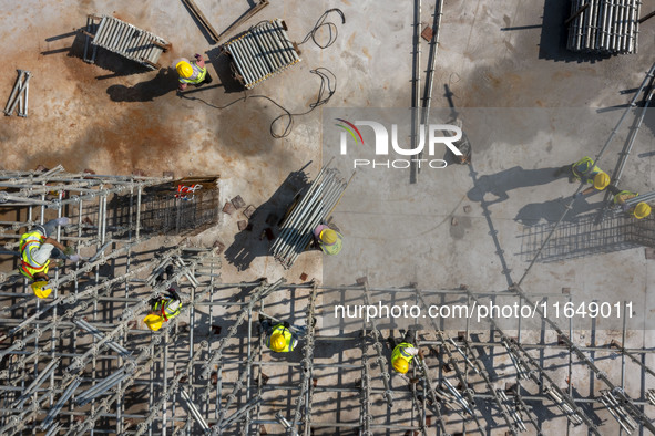 Workers work at the construction site of the second phase of the Foshan -- East and West Guizhou Cooperative Industrial Park in Congjiang Co...