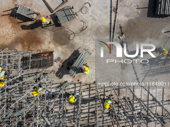 Workers work at the construction site of the second phase of the Foshan -- East and West Guizhou Cooperative Industrial Park in Congjiang Co...