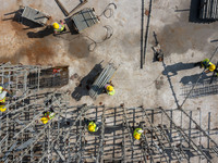 Workers work at the construction site of the second phase of the Foshan -- East and West Guizhou Cooperative Industrial Park in Congjiang Co...