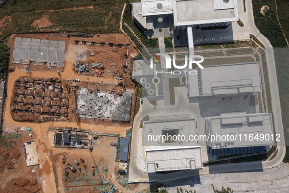 Workers work at the construction site of the second phase of the Foshan -- East and West Guizhou Cooperative Industrial Park in Congjiang Co...