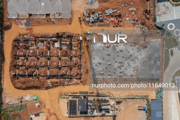 Workers work at the construction site of the second phase of the Foshan -- East and West Guizhou Cooperative Industrial Park in Congjiang Co...