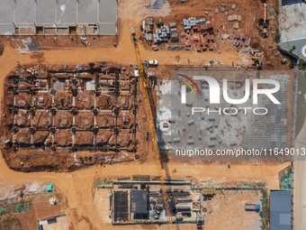 Workers work at the construction site of the second phase of the Foshan -- East and West Guizhou Cooperative Industrial Park in Congjiang Co...