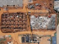 Workers work at the construction site of the second phase of the Foshan -- East and West Guizhou Cooperative Industrial Park in Congjiang Co...