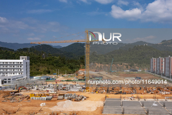 Workers work at the construction site of the second phase of the Foshan -- East and West Guizhou Cooperative Industrial Park in Congjiang Co...