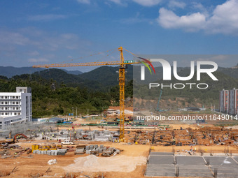 Workers work at the construction site of the second phase of the Foshan -- East and West Guizhou Cooperative Industrial Park in Congjiang Co...