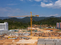 Workers work at the construction site of the second phase of the Foshan -- East and West Guizhou Cooperative Industrial Park in Congjiang Co...