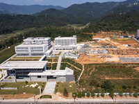 Workers work at the construction site of the second phase of the Foshan -- East and West Guizhou Cooperative Industrial Park in Congjiang Co...