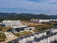 Workers work at the construction site of the second phase of the Foshan -- East and West Guizhou Cooperative Industrial Park in Congjiang Co...