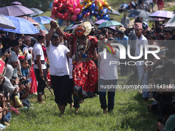 Nepalese devotees impersonate a deity and jump to the tunes of traditional instruments during the celebration of the Shikali Festival in Kho...