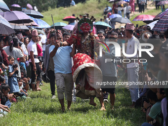 Nepalese devotees impersonate a deity and jump to the tunes of traditional instruments during the celebration of the Shikali Festival in Kho...