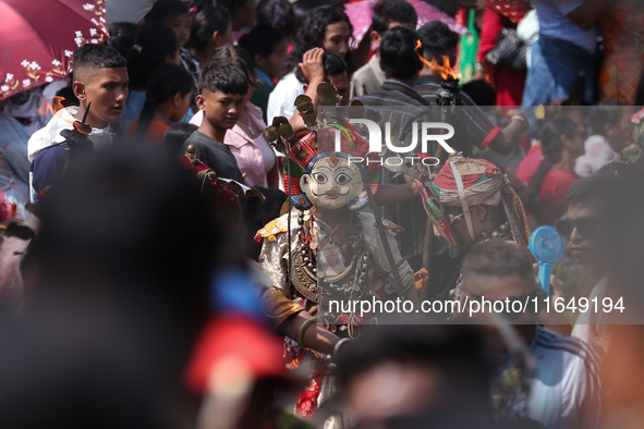 Nepalese devotees impersonate a deity during the celebration of the Shikali Festival in Khokana, Lalitpur, Nepal, on October 8, 2024. 