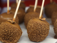 Caramel candy apples are covered with chocolate and sugar at a carnival in Markham, Ontario, Canada, on October 5, 2024. (