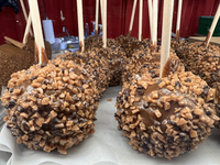 Caramel candy apples are covered with chocolate fudge and nuts at a carnival in Markham, Ontario, Canada, on October 5, 2024. (