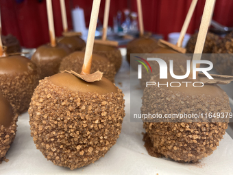 Caramel candy apples are covered with chocolate and sugar at a carnival in Markham, Ontario, Canada, on October 5, 2024. (