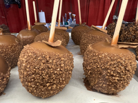 Caramel candy apples are covered with chocolate and sugar at a carnival in Markham, Ontario, Canada, on October 5, 2024. (