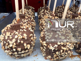 Caramel candy apples are covered with chocolate and nuts at a carnival in Markham, Ontario, Canada, on October 5, 2024. (