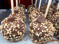 Caramel candy apples are covered with chocolate and nuts at a carnival in Markham, Ontario, Canada, on October 5, 2024. (