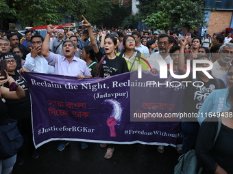 Doctors and citizens shout slogans during a protest march while junior doctors hold a hunger strike to protest against the rape and murder o...