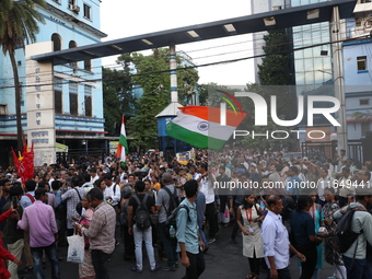 Doctors and citizens shout slogans during a protest march while junior doctors hold a hunger strike to protest against the rape and murder o...