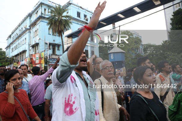 Doctors and citizens shout slogans during a protest march while junior doctors hold a hunger strike to protest against the rape and murder o...