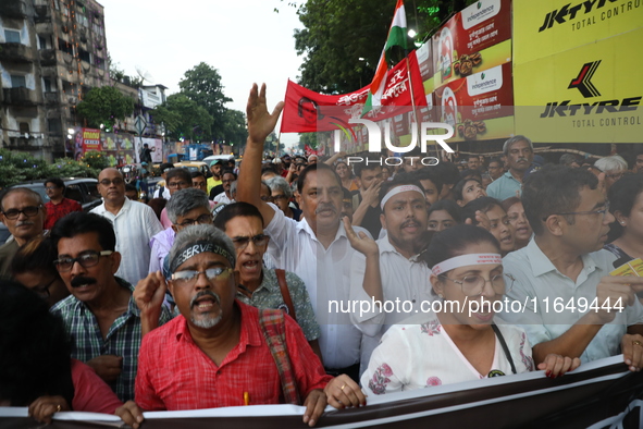 Doctors and citizens shout slogans during a protest march while junior doctors hold a hunger strike to protest against the rape and murder o...