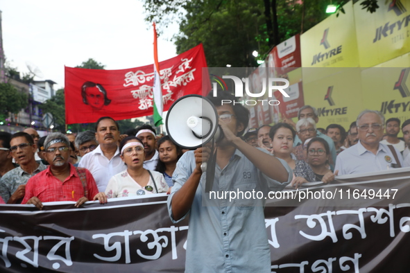 Doctors and citizens shout slogans during a protest march while junior doctors hold a hunger strike to protest against the rape and murder o...