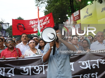 Doctors and citizens shout slogans during a protest march while junior doctors hold a hunger strike to protest against the rape and murder o...