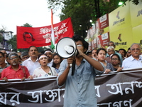 Doctors and citizens shout slogans during a protest march while junior doctors hold a hunger strike to protest against the rape and murder o...