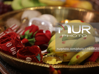 Offerings and other holy items are at a shrine during the Durga Puja festival at a pandal (temporary temple) in Mississauga, Ontario, Canada...