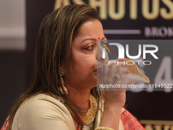 A woman blows a conch as prayers are recited during the Durga Puja festival at a pandal in Mississauga, Ontario, Canada, on October 06, 2024...