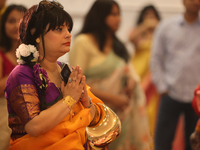 A Bengali Hindu woman offers prayers during the Durga Puja festival at a pandal (temporary temple) in Mississauga, Ontario, Canada, on Octob...