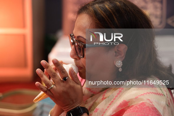 A woman blows a conch as prayers are recited during the Durga Puja festival at a pandal in Mississauga, Ontario, Canada, on October 06, 2024...