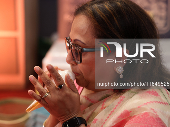 A woman blows a conch as prayers are recited during the Durga Puja festival at a pandal in Mississauga, Ontario, Canada, on October 06, 2024...