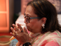 A woman blows a conch as prayers are recited during the Durga Puja festival at a pandal in Mississauga, Ontario, Canada, on October 06, 2024...