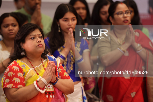 Bengali Hindu women offer prayers during the Durga Puja festival at a pandal (temporary temple) in Mississauga, Ontario, Canada, on October...