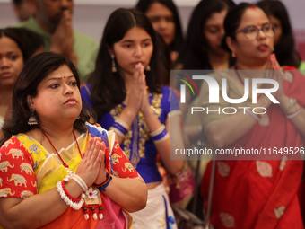 Bengali Hindu women offer prayers during the Durga Puja festival at a pandal (temporary temple) in Mississauga, Ontario, Canada, on October...