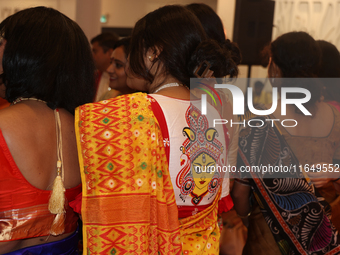 A Bengali Hindu woman wears a saree blouse (choli) with an image of the Goddess Durga during the Durga Puja festival at a pandal (temporary...