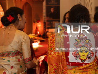 A Bengali Hindu woman wears a saree blouse (choli) with an image of the Goddess Durga during the Durga Puja festival at a pandal (temporary...