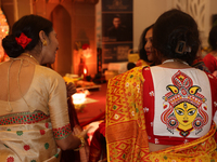 A Bengali Hindu woman wears a saree blouse (choli) with an image of the Goddess Durga during the Durga Puja festival at a pandal (temporary...