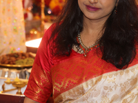 A Bengali Hindu woman dresses in a traditional saree during the Durga Puja festival at a pandal (temporary temple) in Mississauga, Ontario,...