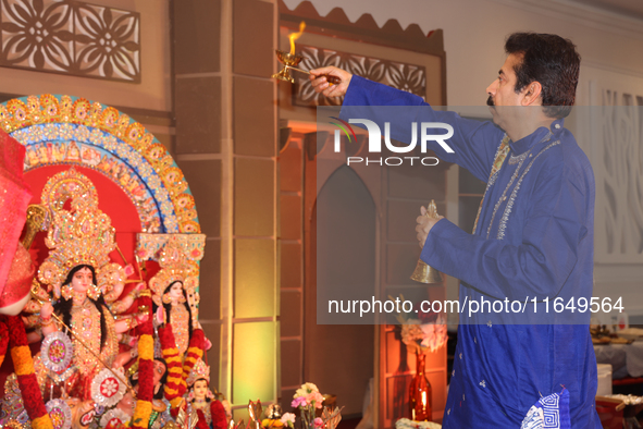 A Bengali Hindu priest performs prayers during the Durga Puja festival at a pandal (temporary temple) in Mississauga, Ontario, Canada, on Oc...