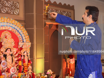 A Bengali Hindu priest performs prayers during the Durga Puja festival at a pandal (temporary temple) in Mississauga, Ontario, Canada, on Oc...