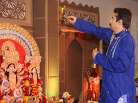 A Bengali Hindu priest performs prayers during the Durga Puja festival at a pandal (temporary temple) in Mississauga, Ontario, Canada, on Oc...