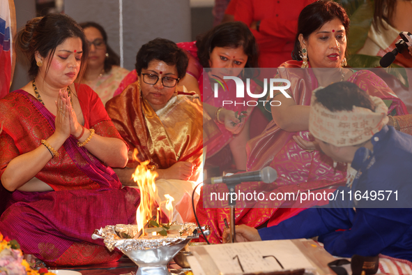 Bengali Hindu women perform prayers during the Durga Puja festival at a pandal (temporary temple) in Mississauga, Ontario, Canada, on Octobe...