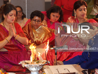 Bengali Hindu women perform prayers during the Durga Puja festival at a pandal (temporary temple) in Mississauga, Ontario, Canada, on Octobe...